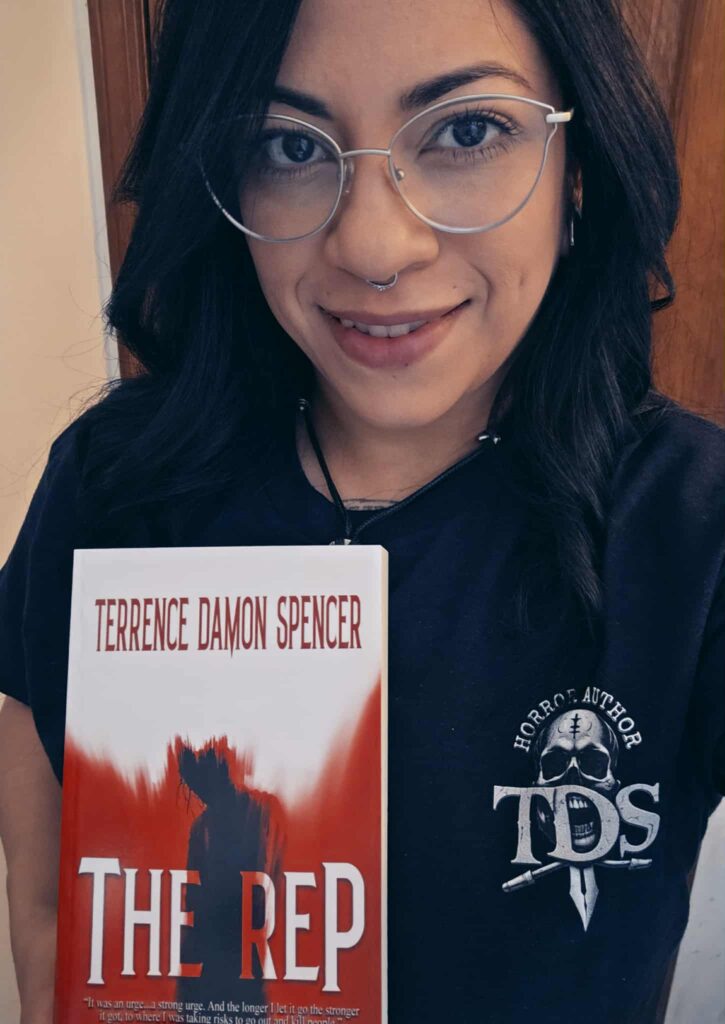 Maddy after receiving her copy of the rewritten novel, The REP by Award Winning Author Terrence Damon Spencer