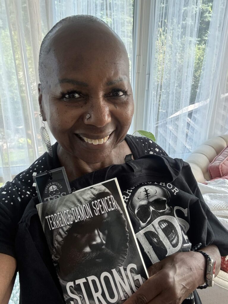 Mary after receiving her copy of Strong by Award Winning Author Terrence Damon Spencer